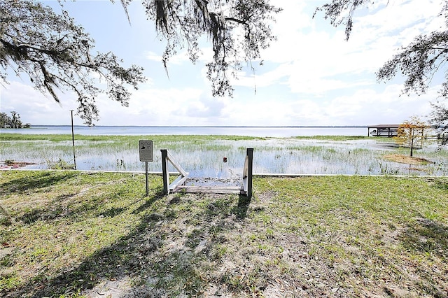 exterior space with a water view and a yard