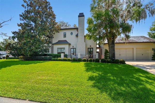 mediterranean / spanish-style house featuring a front yard and a garage