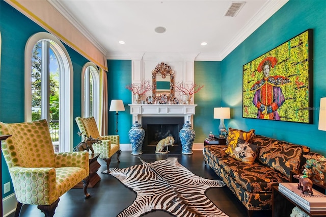 living area with crown molding and wood-type flooring