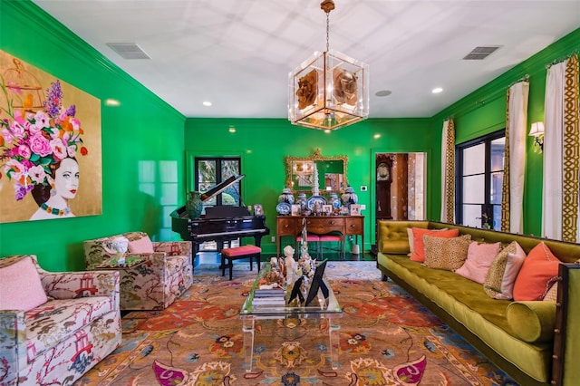 living room with a chandelier and crown molding