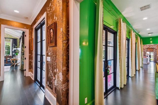 hallway with french doors, ornamental molding, and dark wood-type flooring