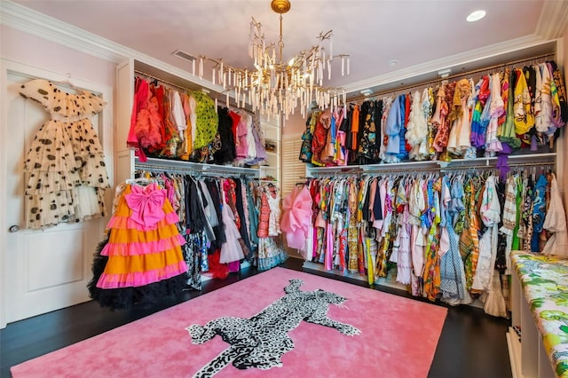 walk in closet featuring a chandelier