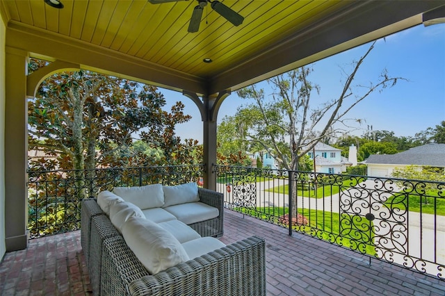 view of patio / terrace with a balcony, an outdoor living space, and ceiling fan