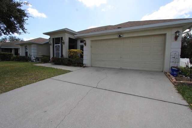 1545 Blue Sky Blvd, Haines City, FL 33844 - ranch-style house featuring driveway, a garage, stucco siding, and a front lawn