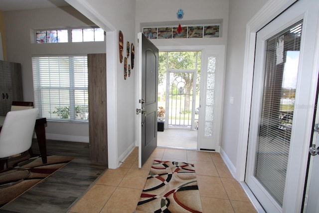 entrance foyer featuring light tile patterned floors and plenty of natural light