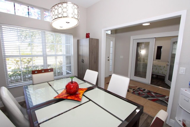 dining space featuring french doors and tile patterned floors