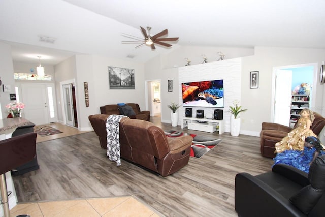 living room featuring ceiling fan, wood-type flooring, and lofted ceiling