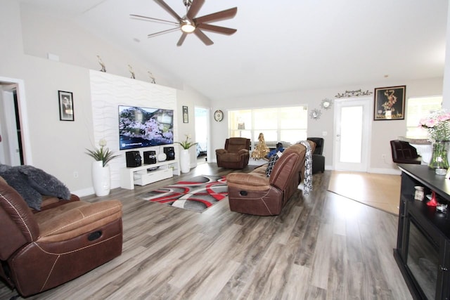 living room featuring high vaulted ceiling, wood-type flooring, and ceiling fan