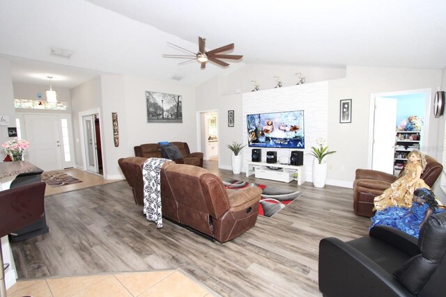 1545 Blue Sky Blvd, Haines City, FL 33844 - living room with a ceiling fan, lofted ceiling, wood finished floors, and baseboards