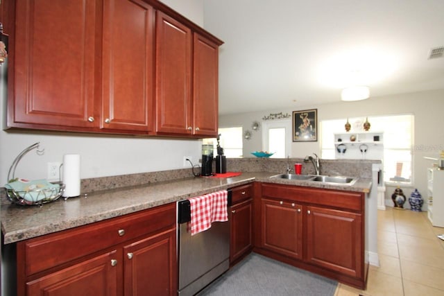 kitchen with stainless steel dishwasher, kitchen peninsula, sink, and light tile patterned flooring