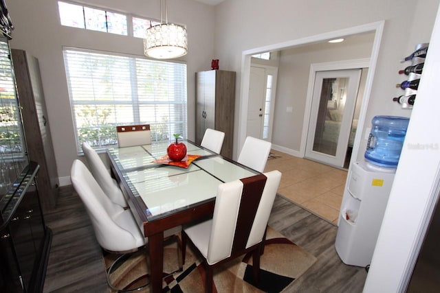 1545 Blue Sky Blvd, Haines City, FL 33844 - dining area featuring wood finished floors, baseboards, and a chandelier