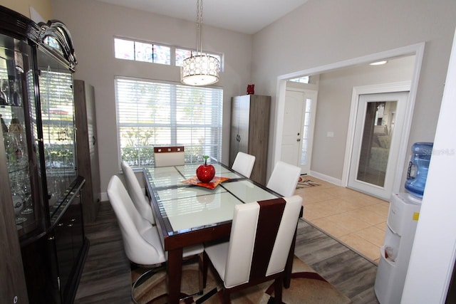 tiled dining room with a notable chandelier and a wealth of natural light