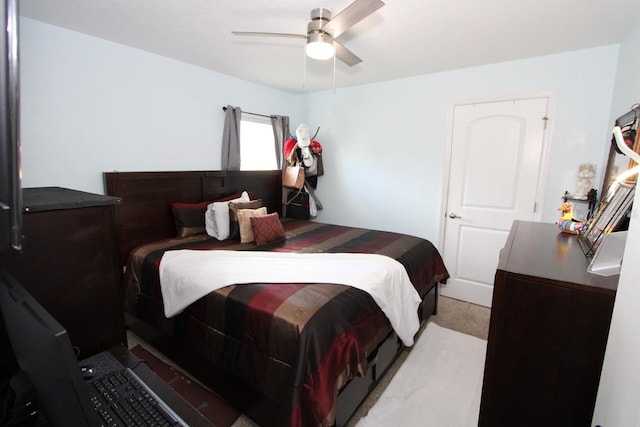 bedroom featuring light colored carpet and ceiling fan