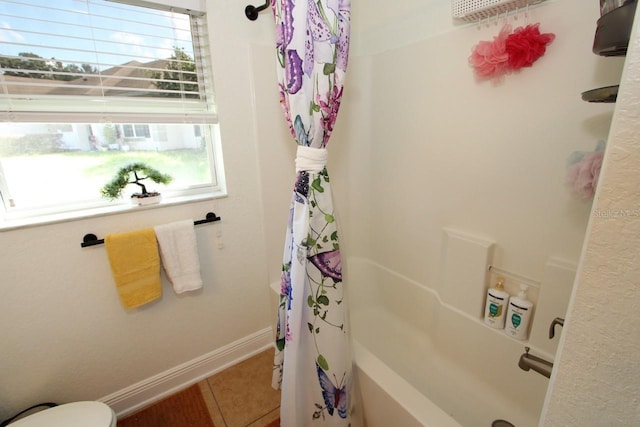 bathroom featuring shower / tub combo with curtain, tile patterned floors, and toilet