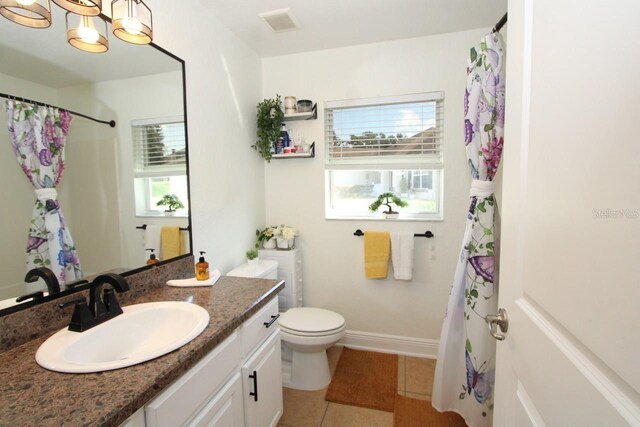 1545 Blue Sky Blvd, Haines City, FL 33844 - full bath with tile patterned flooring, vanity, toilet, a chandelier, and baseboards