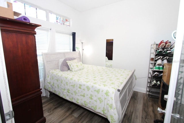 bedroom with dark wood-type flooring