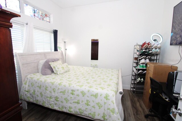 1545 Blue Sky Blvd, Haines City, FL 33844 - bedroom featuring dark wood finished floors, baseboards, and a desk