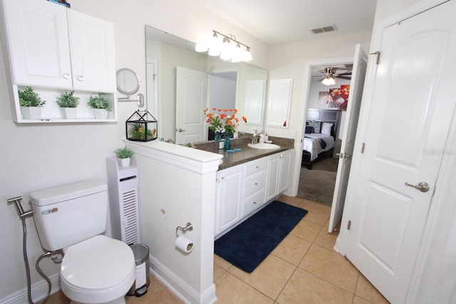 bathroom featuring vanity, toilet, tile patterned floors, and ceiling fan