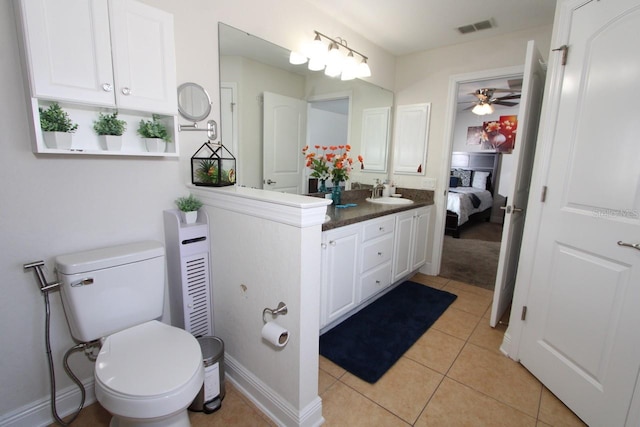 bathroom featuring vanity, toilet, tile patterned flooring, and ceiling fan