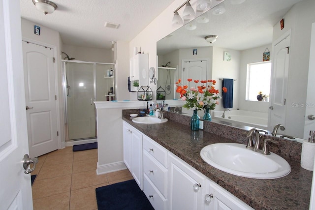 bathroom with vanity, plus walk in shower, and a textured ceiling