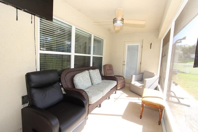 sunroom / solarium featuring ceiling fan