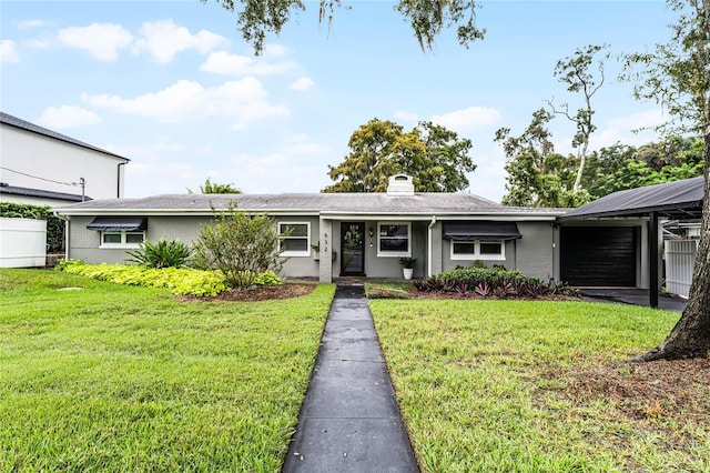 single story home with a front yard and a garage