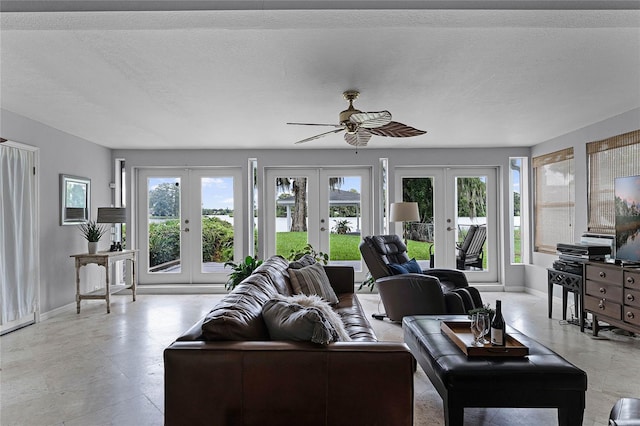 living room with french doors, a textured ceiling, and ceiling fan