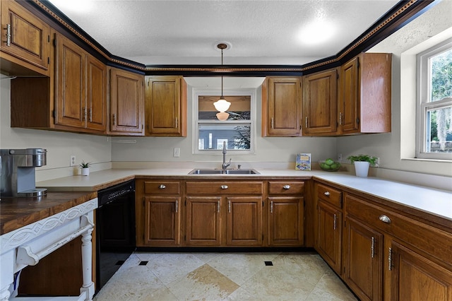 kitchen with black dishwasher, a textured ceiling, sink, and decorative light fixtures