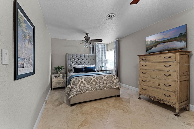 bedroom with a textured ceiling and ceiling fan