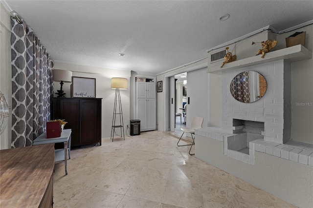 interior space with a fireplace and a textured ceiling