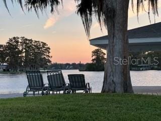 dock area featuring a yard and a water view