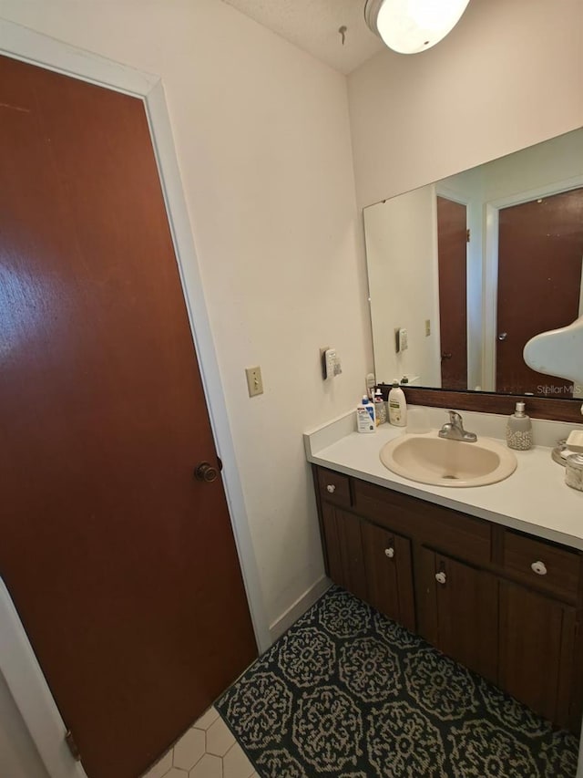 bathroom with vanity and tile patterned flooring