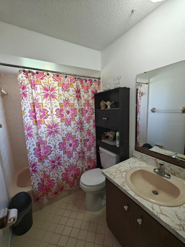 full bathroom featuring vanity, toilet, a textured ceiling, and shower / bath combo