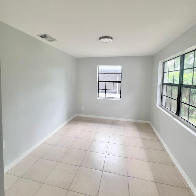 tiled empty room with plenty of natural light