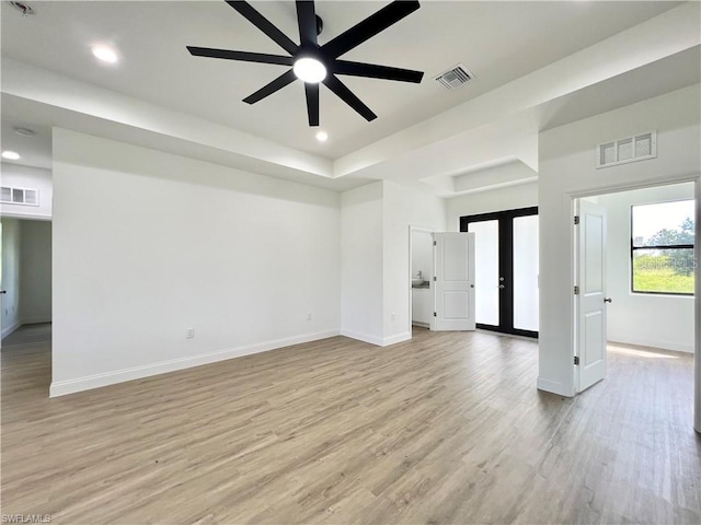 unfurnished room featuring french doors, light hardwood / wood-style floors, and ceiling fan