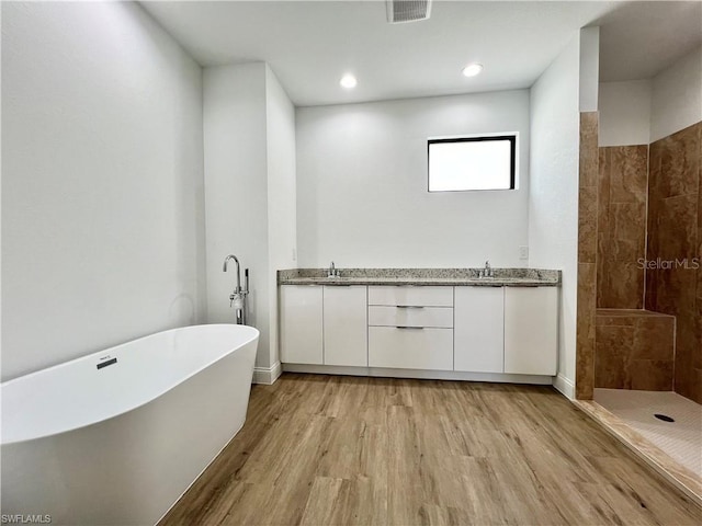 bathroom with vanity, independent shower and bath, and hardwood / wood-style flooring