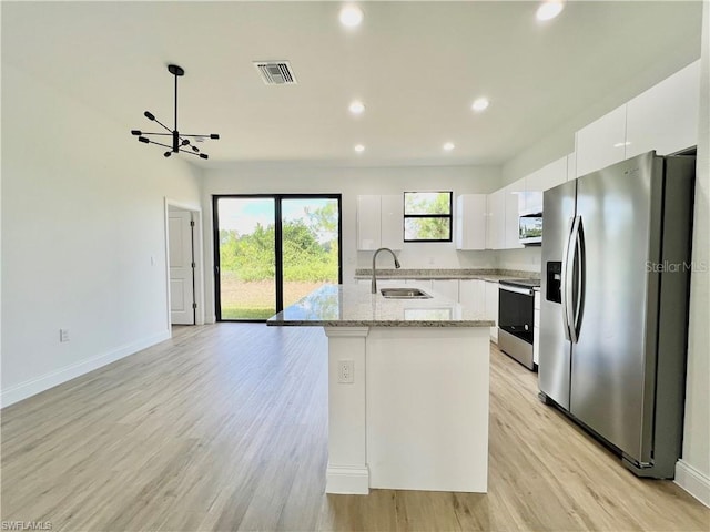 kitchen featuring a kitchen island, sink, light wood-type flooring, white cabinetry, and appliances with stainless steel finishes