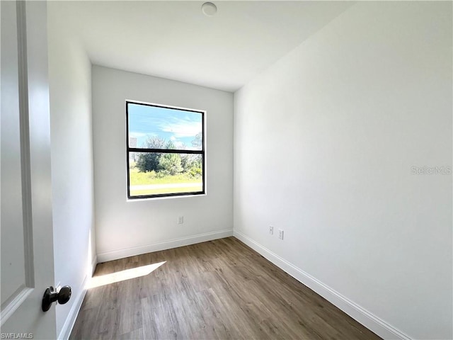 unfurnished room featuring hardwood / wood-style floors