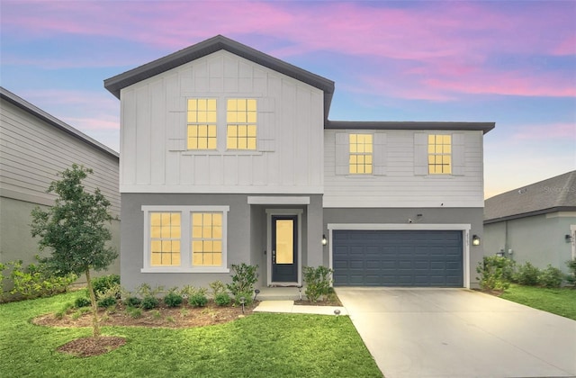 view of front of property with a lawn and a garage