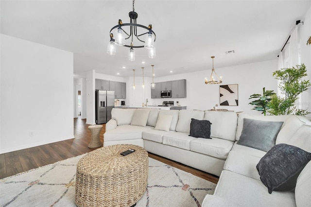 living room featuring wood-type flooring and a chandelier