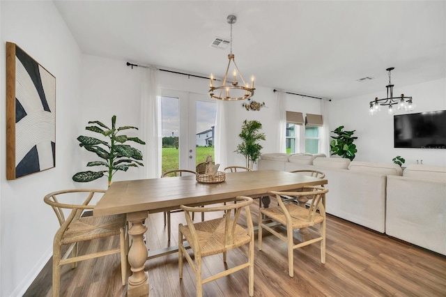 dining space featuring hardwood / wood-style floors, french doors, and plenty of natural light