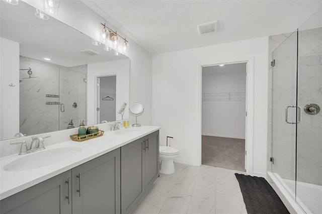 bathroom with vanity, toilet, and walk in shower