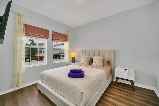 bedroom with dark wood-type flooring