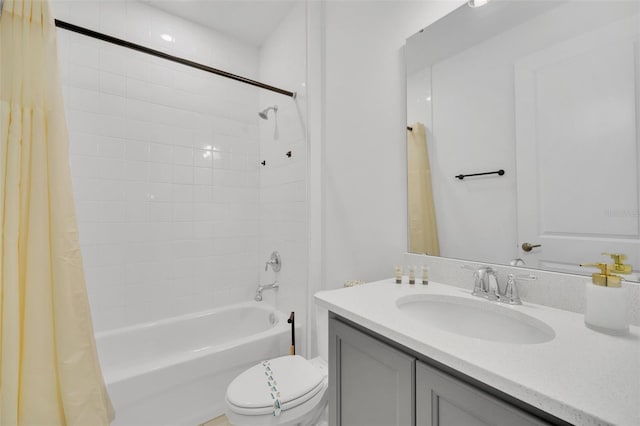 full bathroom with vanity, shower / tub combo, and toilet