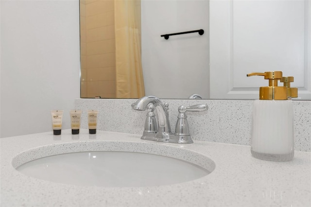 interior details featuring vanity and decorative backsplash