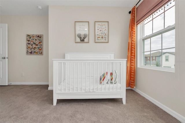 carpeted bedroom with a crib