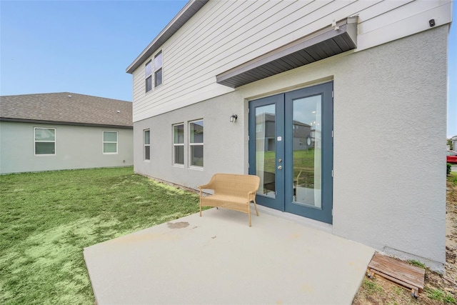 back of property featuring a patio, french doors, and a lawn