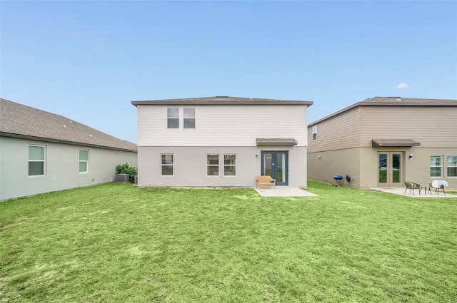 back of house with central AC unit, french doors, a patio, and a lawn