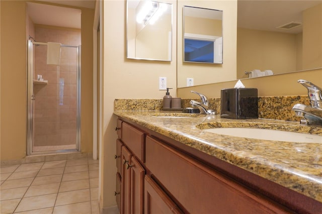 bathroom with vanity, tile patterned floors, and a shower with shower door