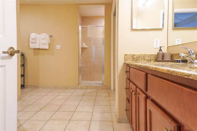 bathroom featuring tile patterned flooring, vanity, and an enclosed shower